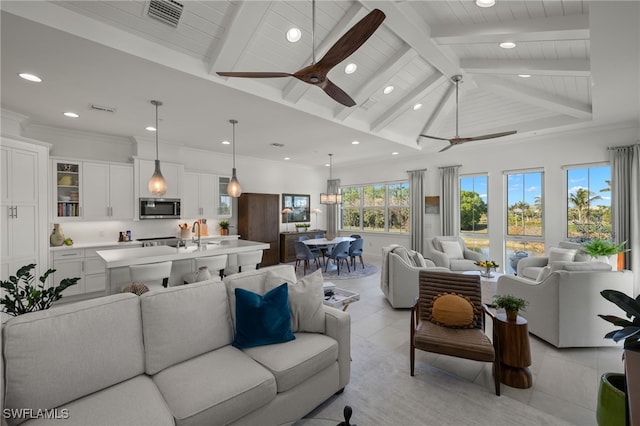 living room featuring light tile patterned floors, visible vents, lofted ceiling with beams, and ceiling fan