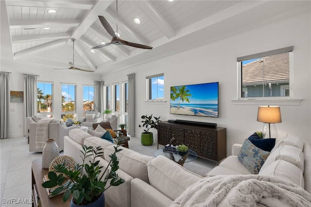 living area with tile patterned floors, plenty of natural light, and beamed ceiling