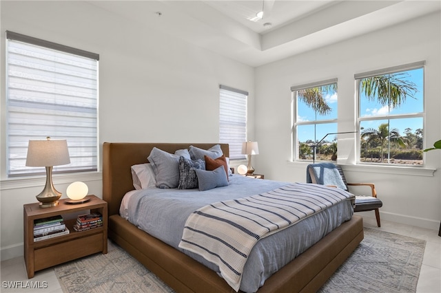 bedroom featuring light tile patterned floors and baseboards