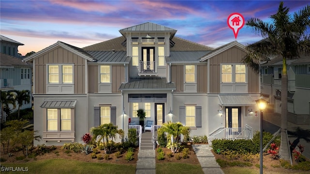 townhome / multi-family property with board and batten siding, metal roof, and a standing seam roof