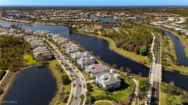 birds eye view of property with a water view and a residential view