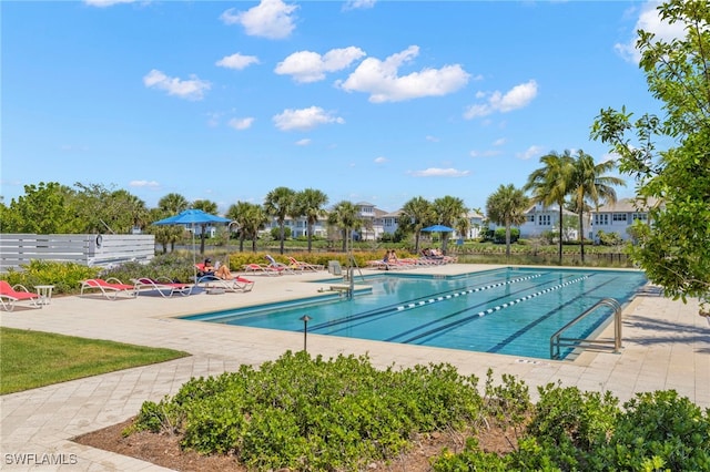 community pool featuring a patio and fence