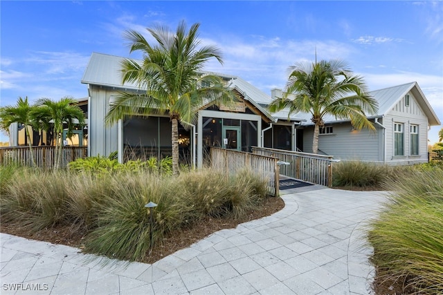 view of front of property with fence and board and batten siding