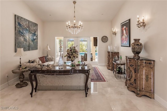 living area featuring an inviting chandelier and french doors