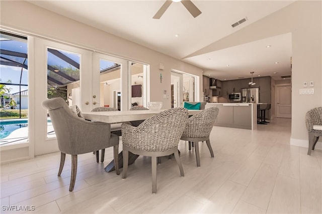 dining space with light hardwood / wood-style floors, lofted ceiling, and ceiling fan