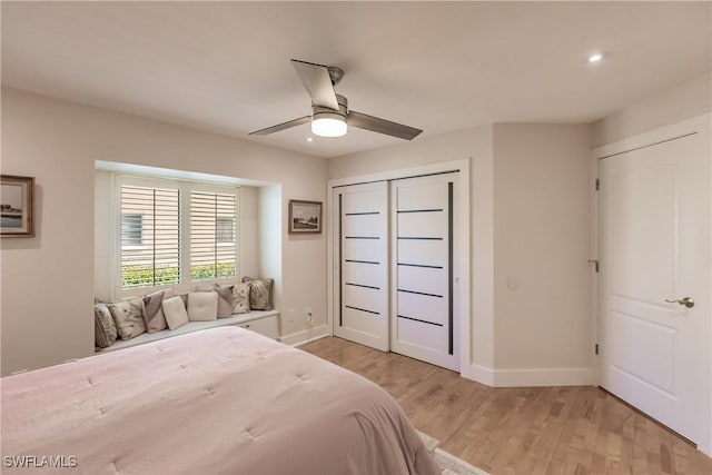 bedroom featuring light wood-type flooring, a closet, and ceiling fan