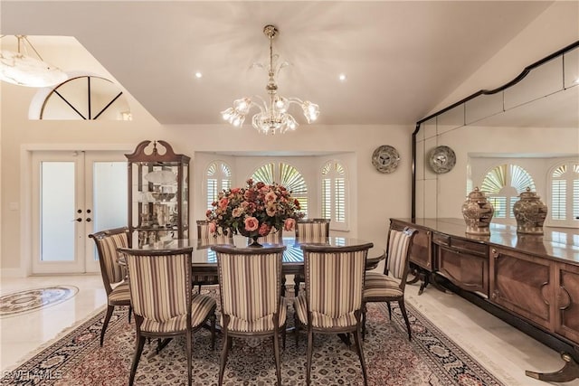 dining room featuring french doors, vaulted ceiling, a chandelier, and a wealth of natural light