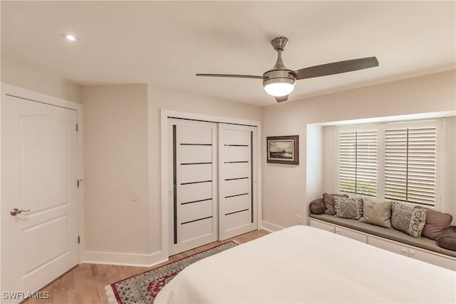 bedroom with light wood-type flooring, a closet, and ceiling fan