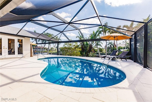 view of swimming pool featuring a patio area, french doors, and glass enclosure