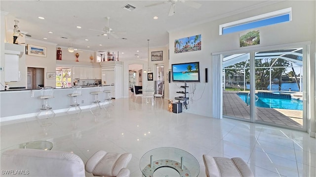 living room featuring crown molding and ceiling fan