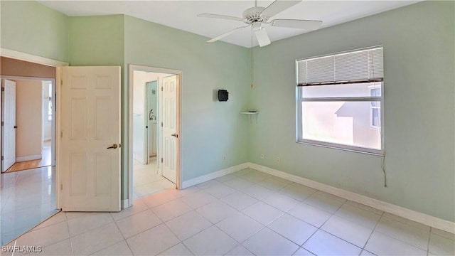 unfurnished bedroom featuring light tile patterned floors and ceiling fan