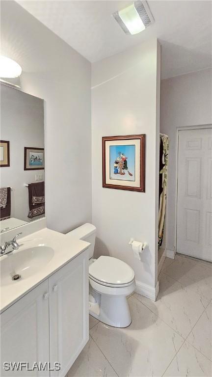 bathroom with vanity and toilet