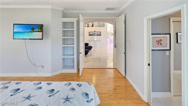 bedroom featuring wood-type flooring and crown molding