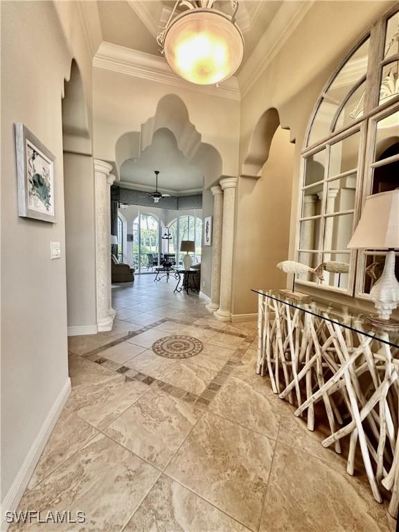 hallway featuring ornate columns and ornamental molding