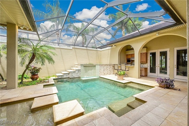 9411 Monteverdi Way, Fort Myers, FL 33912 - swimming pool featuring exterior kitchen, a patio, french doors, and a lanai
