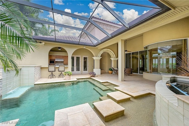 9411 Monteverdi Way, Fort Myers, FL 33912 - swimming pool with a patio area, french doors, exterior kitchen, and glass enclosure