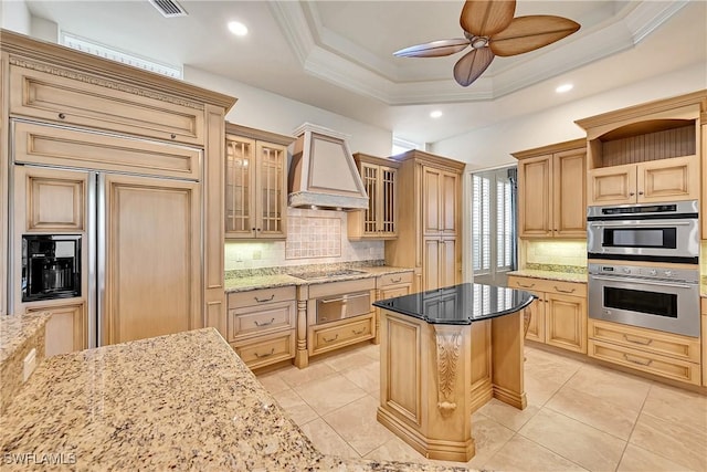 9411 Monteverdi Way, Fort Myers, FL 33912 - kitchen with a warming drawer, paneled built in refrigerator, custom range hood, decorative backsplash, and ornamental molding