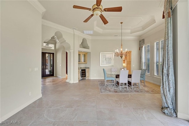 9411 Monteverdi Way, Fort Myers, FL 33912 - dining space with beverage cooler, ornamental molding, ceiling fan, baseboards, and a tray ceiling