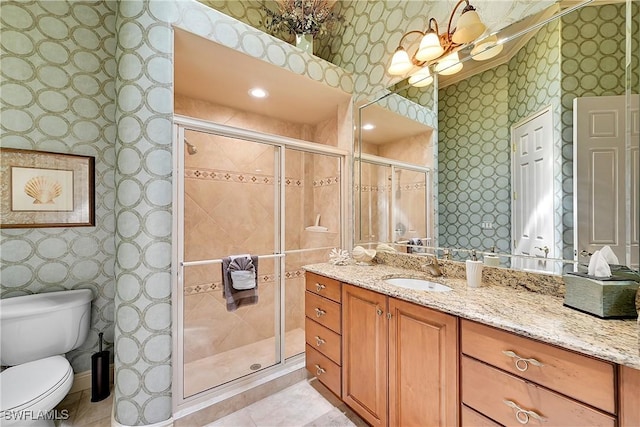 9411 Monteverdi Way, Fort Myers, FL 33912 - bathroom with wallpapered walls, a shower stall, vanity, and toilet