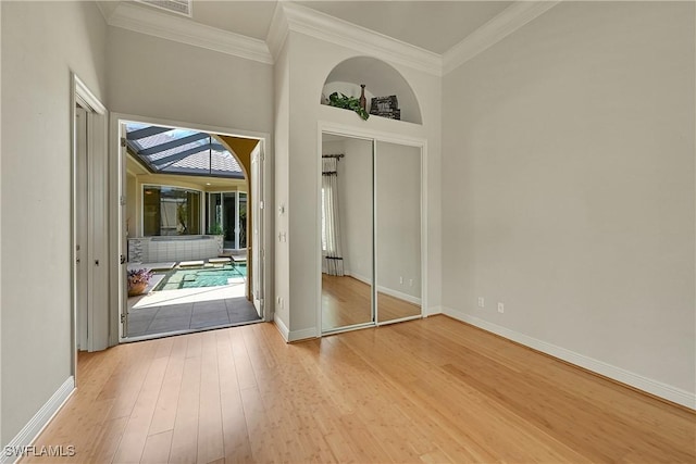 9411 Monteverdi Way, Fort Myers, FL 33912 - unfurnished bedroom with wood finished floors, crown molding, and baseboards