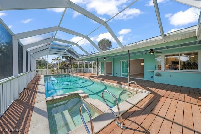 view of pool with ceiling fan and a lanai