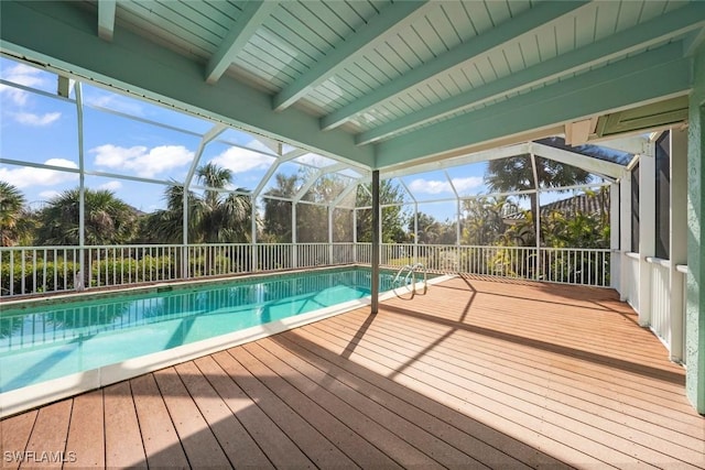 view of swimming pool featuring glass enclosure