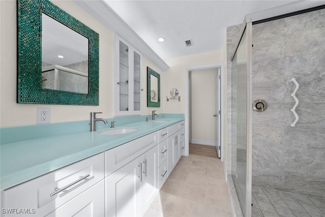 bathroom with vanity and tiled shower