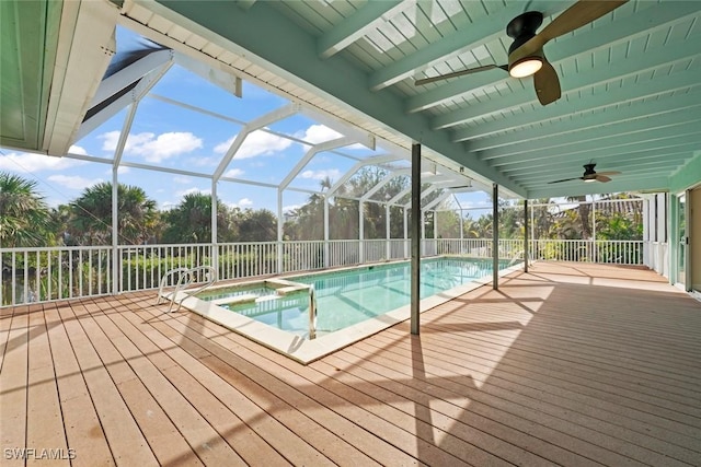 view of pool with an in ground hot tub and glass enclosure