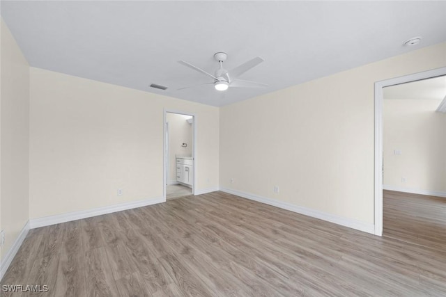 empty room featuring ceiling fan and light hardwood / wood-style flooring