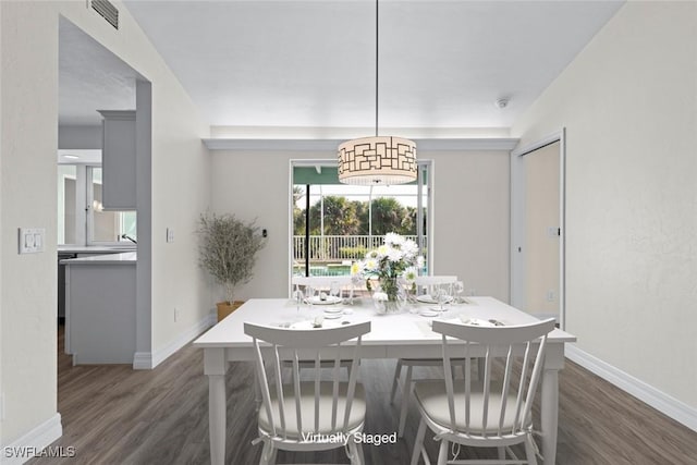 dining space featuring dark hardwood / wood-style floors