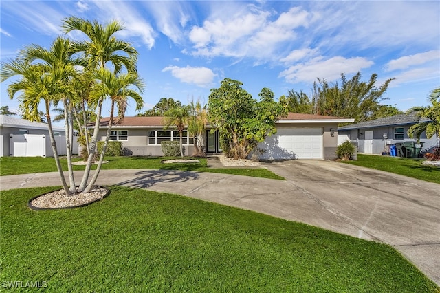 ranch-style house with a garage and a front lawn