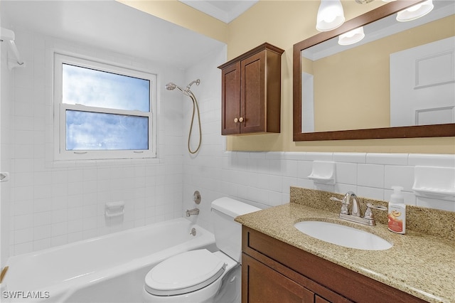 full bathroom with tile walls, vanity, tiled shower / bath combo, and toilet