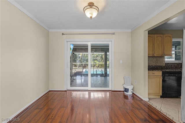 unfurnished dining area with ornamental molding, dark hardwood / wood-style floors, and a textured ceiling