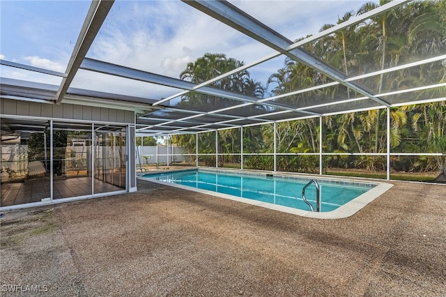 view of swimming pool with a lanai and a patio