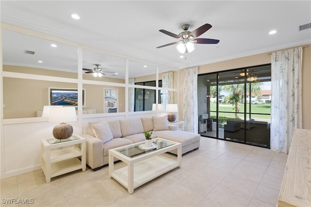 tiled living room with ceiling fan and ornamental molding