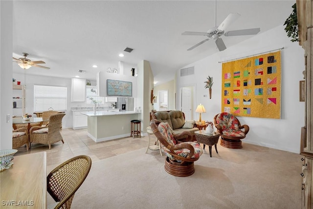 carpeted living room with vaulted ceiling and ceiling fan