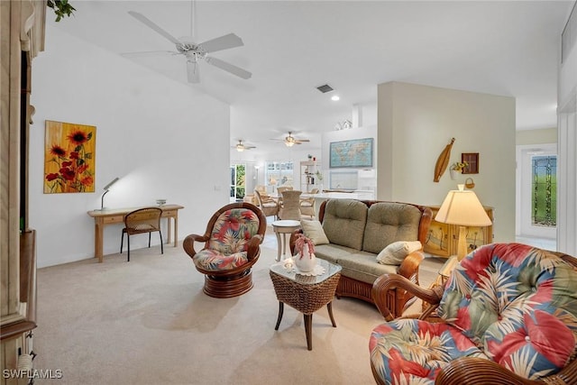 carpeted living room with vaulted ceiling and ceiling fan