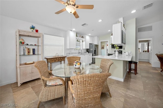 dining area featuring vaulted ceiling, ceiling fan, radiator heating unit, and sink