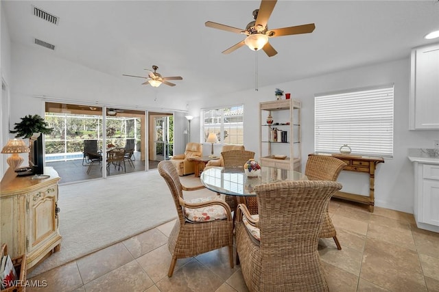 dining area with light carpet and ceiling fan