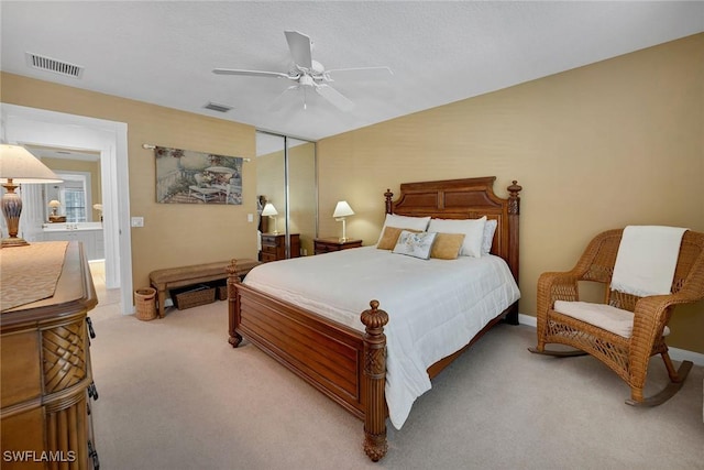 bedroom with light carpet, a closet, and ceiling fan