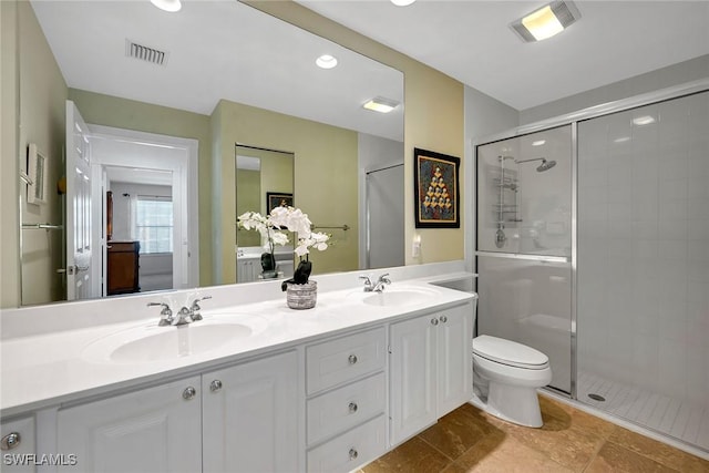 bathroom featuring tile patterned floors, vanity, toilet, and an enclosed shower