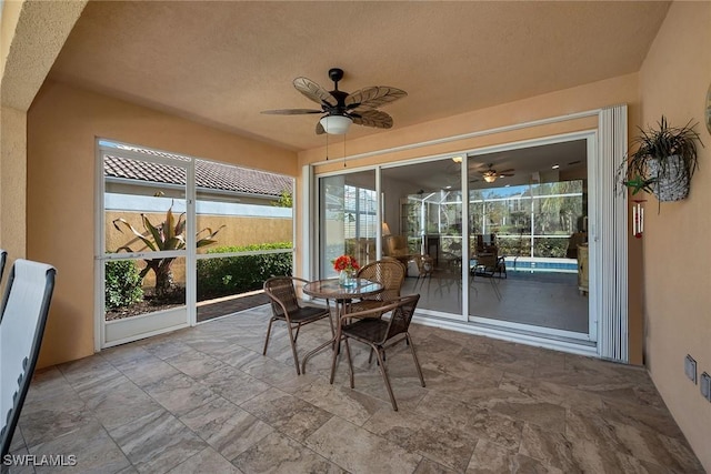 sunroom / solarium featuring ceiling fan