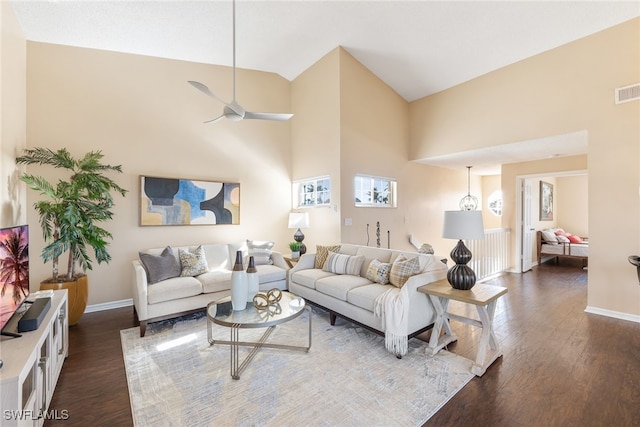 living room with ceiling fan, dark hardwood / wood-style floors, and high vaulted ceiling