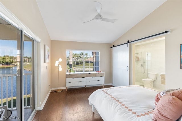 bedroom with multiple windows, a barn door, access to outside, and lofted ceiling