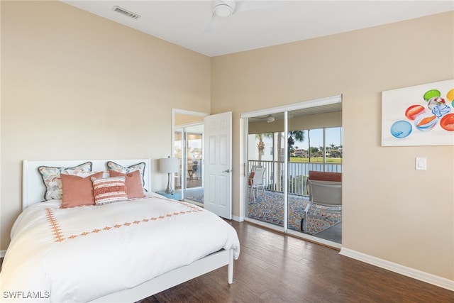 bedroom with a water view, dark wood-type flooring, access to exterior, and ceiling fan