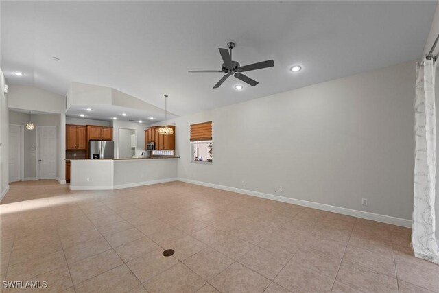 unfurnished living room featuring vaulted ceiling, light tile patterned floors, and ceiling fan