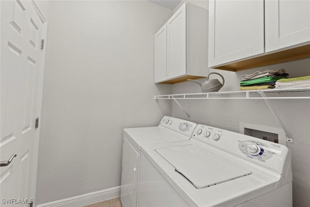 laundry room featuring cabinets and washing machine and dryer