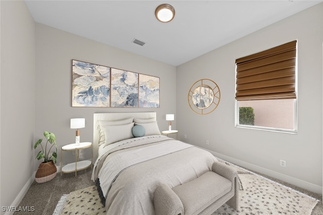 bedroom with baseboards, visible vents, and carpet flooring