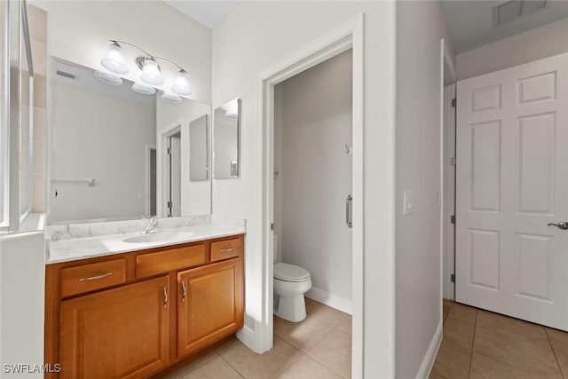 bathroom featuring vanity, tile patterned floors, and toilet