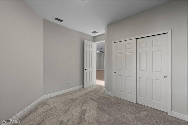 unfurnished bedroom featuring carpet floors, visible vents, and baseboards